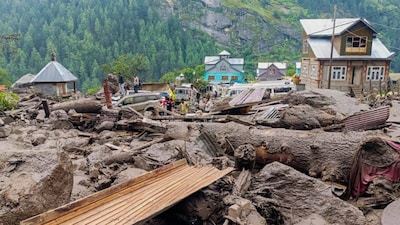 People move through the debris after a massive cloudburst at Chasoti village, in Jammu and Kashmir's Kishtwar district. (PTI photo)