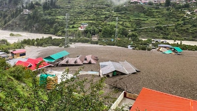 Houses partially submerged following mudslide and flash floods triggered by a cloudburst at Kheer Gad area in Dharali of Uttarkashi district. (PTI)