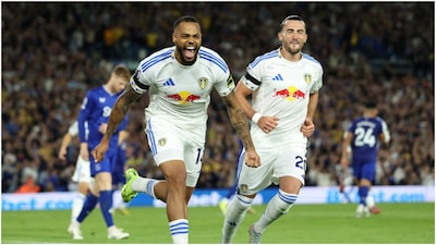 Leeds United's German striker #14 Lukas Nmecha (L) celebrates after scoring the opening goal from the penalty spot  (Photo by Darren Staples / AFP) /