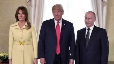 U .S. First Lady Melania Trump, U.S. President Donald Trump and Russian President Vladimir Putin, from left, pose for a photograph at the Presidential Palace in Helsinki, Finland. (Sputnik, Kremlin Pool Photo via AP File)
