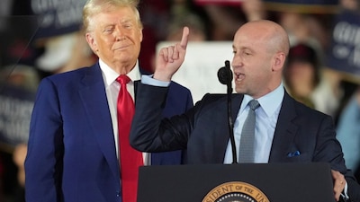 President Donald Trump listens as White House deputy chief of staff for policy Stephen Miller speaks on his first 100 days at Macomb County Community College Sports Expo Center in April. (AP)