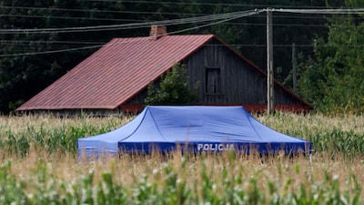 A police tent is set up in the area, after an unidentified object fell and exploded in a cornfield overnight (Reuters image)