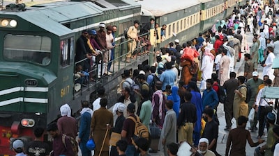 Pakistanis board a train at a railway station in Lahore. (AFP file photo)