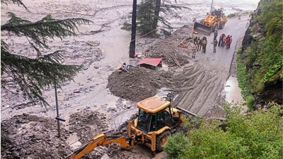 An excavator being used to clear debris from a road following flash floods triggered by a cloudburst, near Harsil in Uttarkashi district, Uttarakhand. (File pic/PTI)