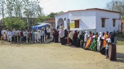 Voters wait in queues at a polling station to cast their votes in Bihar’s Gaya district. (IMAGE: PTI FILE) 