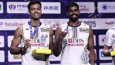 Satwiksairaj Rankireddy (right) and Chirag Shetty pose on the podium at the Badminton World Championships. (AFP Photo)