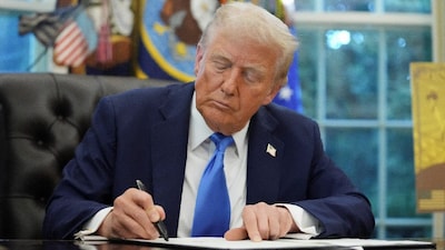 US President Donald Trump signs an executive order on gold card visa in the Oval Office at the White House in Washington, DC, US. (IMAGE: REUTERS)