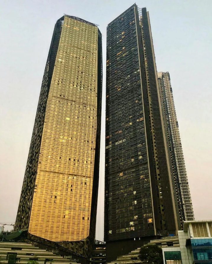 Lodha Trump Tower, Mumbai: With a height of 268 metres and 76 floors, this Worli-located residential building is the 6th tallest building in India. Completed in 2020, it also boasts the Trump brand affiliation. Along with this, the Lodha Marquise, Lodha Allura, Lodha Parkside, and Lodha Kiara also have the same height and share the sixth spot. They are all located in Mumbai. Lodha Trump Tower, Mumbai: With a height of 268 metres and 76 floors, this Worli-located residential building is the 6th tallest building in India. Completed in 2020, it also boasts the Trump brand affiliation. Along with this, the Lodha Marquise, Lodha Allura, Lodha Parkside, and Lodha Kiara also have the same height and share the sixth spot. They are all located in Mumbai.