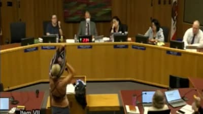 The woman removed her clothes to reveal a bikini, drawing immediate objections from board officials. (Image Credit: X)