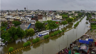 A bus moves through a waterlogged road after heavy rainfall, in Jalandhar, Punjab. (PTI)