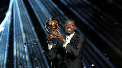 Paris Saint-Germain's Ousmane Dembélé receives the 2025 Men's Ballon d'Or during the 69th Ballon d'Or awards ceremony at the Theatre du Chatelet in Paris, Monday, Sept. 22, 2025. (AP Photo/Thibault Camus)
