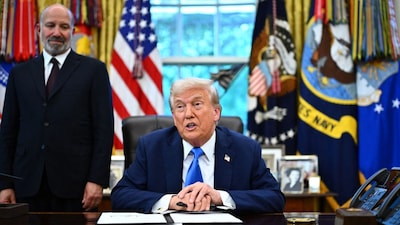 US President Donald Trump speaks before signing an executive order in the Oval Office at the White House in Washington, DC, as commerce secretary Howard Lutnick (L) looks on. (Image: AFP/File)