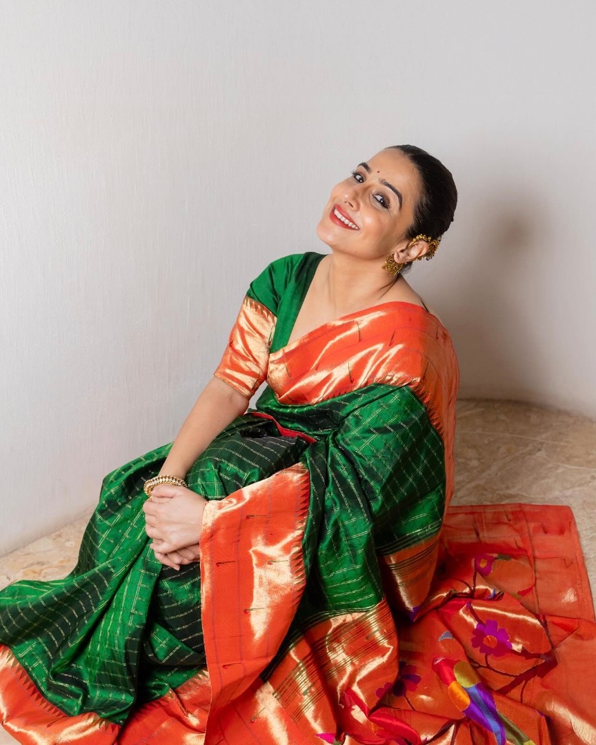 On Day 5, Vidya outshone in a deep green Paithani silk saree with an exquisite orange border. A matching blouse was the perfect choice. On Day 5, Vidya outshone in a deep green Paithani silk saree with an exquisite orange border. A matching blouse was the perfect choice.