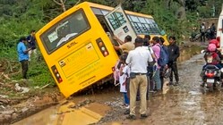 A school bus carrying children nearly toppled after slipping into slush on a pothole-ridden road, in Bengaluru, Karnataka, Friday, Sept. 12, 2025. (Image: PTI)
