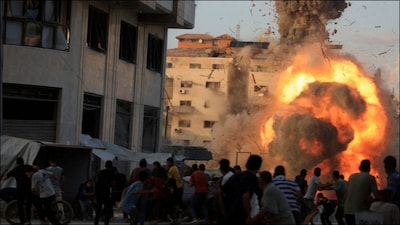 Smoke and flames rise while a residential building collapses after an Israeli air strike, in Gaza City. (Reuters)