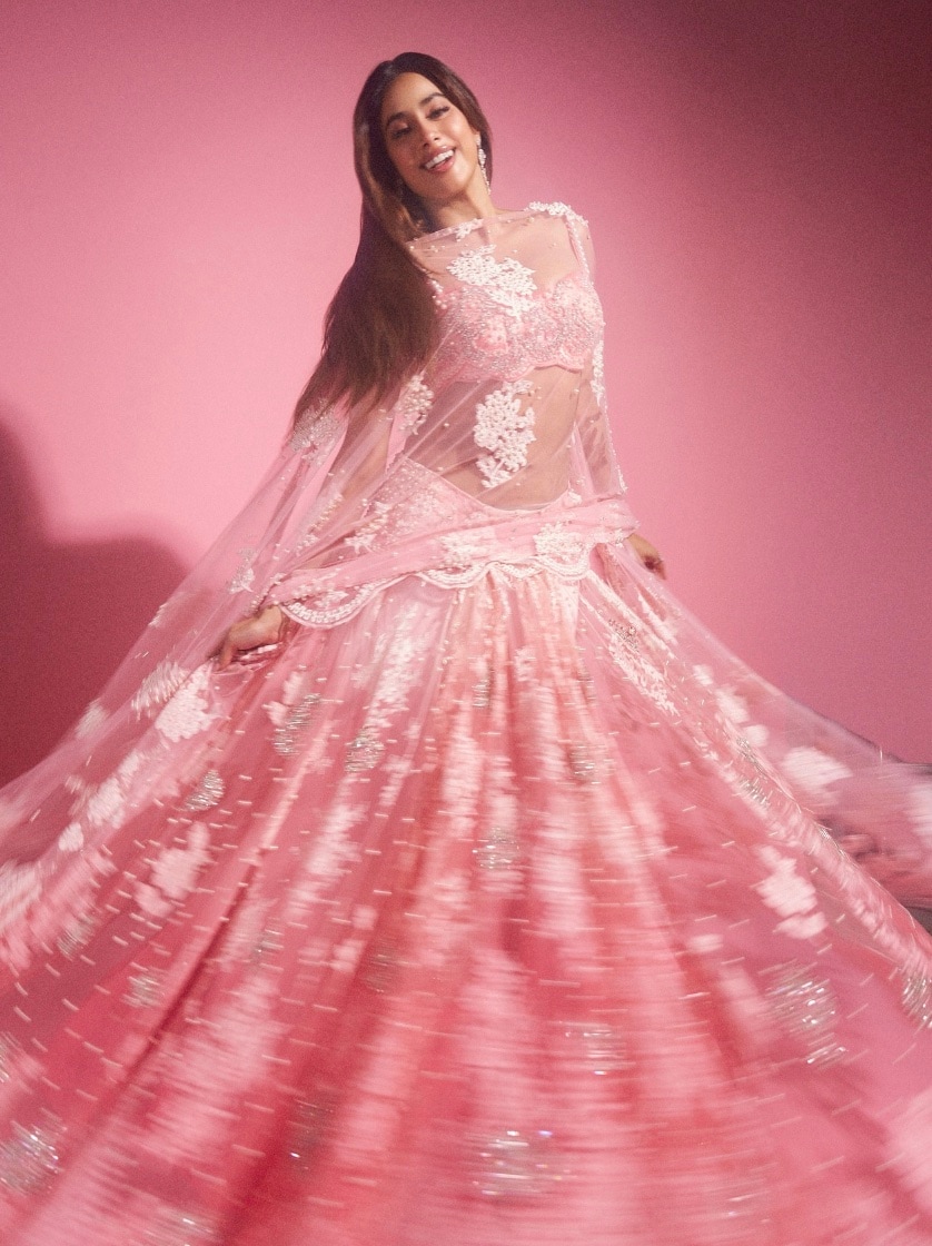 Blush Pink Lehenga: Just like Janhvi Kapoor, you can choose a blush pink or any pastel-colored lehenga to effortlessly slay your festive night. Opt for a sheer, delicately embroidered blouse paired with a flowing skirt adorned with intricate embellishments. To take the look up a notch, consider adding floral appliques and shimmering sequins for that extra touch of glam.