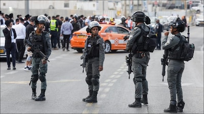 Israeli police stand guard near the scene where a suspected shooting attack in Jerusalem. (Reuters)