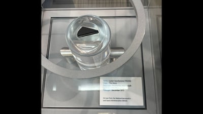 nside a secure glass display rests a jet-black fragment of lunar basalt, estimated to be 3.5 billion years old. (News18)