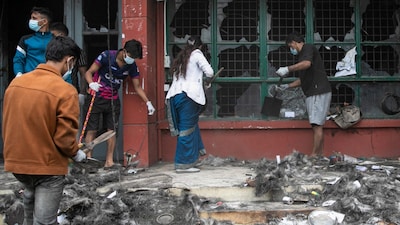 Volunteers clear the remains and ravages of the torched office building of Nepal's Department of Transport Management (DOTM) in Kathmandu. (AFP photo)