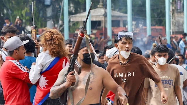 A protester carries a firearm as demonstrators gather outside the Singha Durbar palace complex during a protest in Kathmandu on September 9. (AFP photo)