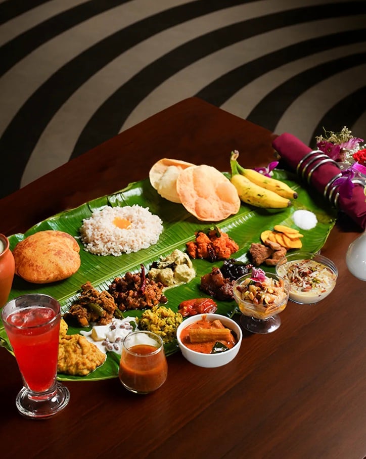 6. Kalpaney, Bengaluru: Kalpaney brings the rich tradition of Kerala’s Onam Sadhya to Bengaluru with an elaborate vegetarian feast featuring avial, olan, kaalan, erissery, pachadi, sambar, rasam, Kerala matta rice, and desserts like palada payasam. Location: Kalpaney, JP Nagar | Date: 5th Septermber 2025 | Time: 12:00 PM to 4:00 PM | Price: INR 979 + taxes 6. Kalpaney, Bengaluru: Kalpaney brings the rich tradition of Kerala’s Onam Sadhya to Bengaluru with an elaborate vegetarian feast featuring avial, olan, kaalan, erissery, pachadi, sambar, rasam, Kerala matta rice, and desserts like palada payasam. Location: Kalpaney, JP Nagar | Date: 5th Septermber 2025 | Time: 12:00 PM to 4:00 PM | Price: INR 979 + taxes
