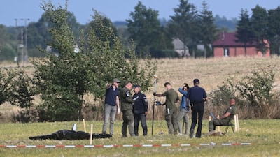Police and Military Police secure parts of a damaged UAV shot down by Polish authorities at a site in Wohyn. (AP photo)