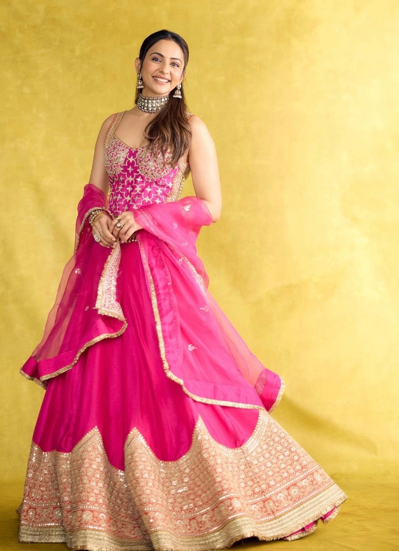 Just like Rakul Preet Singh, stand out from the crowd in an embroidered choli with a pink lehenga with a golden border. Just like Rakul Preet Singh, stand out from the crowd in an embroidered choli with a pink lehenga with a golden border.