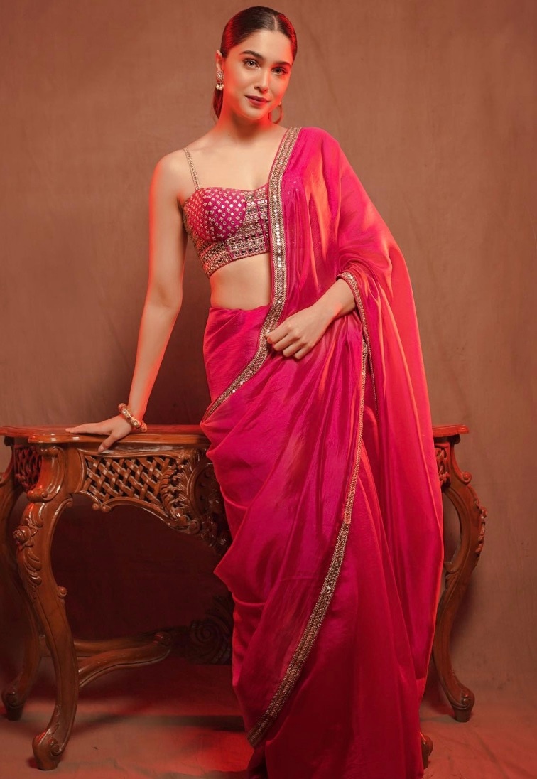 Choose a simple yet striking deep pink silk saree with an ornate bralette-style blouse, like Sharvari. Choose a simple yet striking deep pink silk saree with an ornate bralette-style blouse, like Sharvari.