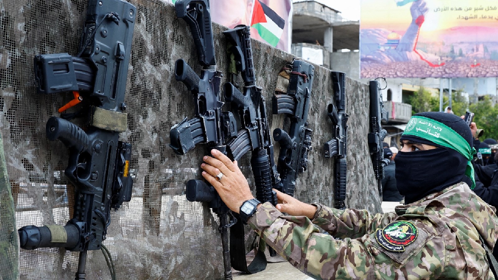 A Palestinian Hamas militant displays guns in Rafah in the southern Gaza Strip. A Palestinian Hamas militant displays guns in Rafah in the southern Gaza Strip.