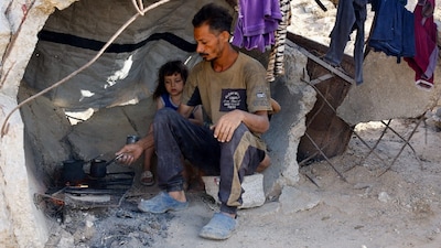 Palestinians, displaced from northern Gaza due to an Israeli military operation, take shelter, after evacuating southwards, following Israeli forces' orders to leave Gaza City, in the central Gaza Strip. (IMAGE: REUTERS) 