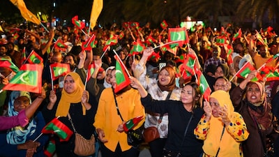 Opposition supporters wave Maldivian national flags during an anti-government protest in Male, Maldives. (IMAGE: AP PHOTO)