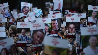 People hold up posters of hostages in Hamas captivity in Gaza, to demand their release, in Buenos Aires, Argentina (File photo/AP)