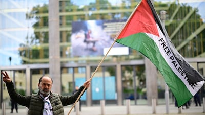 A man waves a Palestinian national flag during a protest titled 
