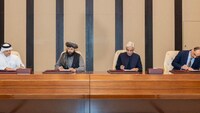 Afghan Defence Minister, Mullah Mohammad Yaqoob Mujahid and Pakistan's Defence Minister, Khawaja Muhammad Asif sign documents of a ceasefire agreement, during a negotations meeting mediated by Qatar and Turkey, in Doha, Qatar.