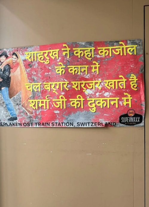 In her next slide, Kajol showed her playful side. She added the photo of a hilarious banner that read, “Shah Rukh ne kaha Kajol ke kaan mein, chal burger aur sharbat khate hain Sharma ji ki dukaan mein.” In her next slide, Kajol showed her playful side. She added the photo of a hilarious banner that read, “Shah Rukh ne kaha Kajol ke kaan mein, chal burger aur sharbat khate hain Sharma ji ki dukaan mein.”