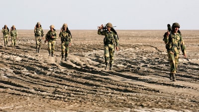 India's Border Security Force soldiers patrol near the international border with Pakistan at Sir Creek, Gujarat, November 25, 2009. (REUTERS)