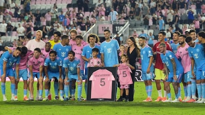Inter Miami midfielder Sergio Busquets, center, poses for a picture with teammates and his family as the team celebrates his career following an MLS soccer match against New England Revolution, Saturday, Oct. 4, 2025, in Fort Lauderdale, Fla. (AP Photo/Rebecca Blackwell)
