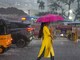 A woman walks with an umbrella on a road during heavy rainfall, in Chennai on Tuesday. (PTI file photo)