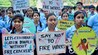 School students hold placards promoting a 'Green Diwali' without firecrackers in Ambala Cantt on Tuesday. (PTI photo)