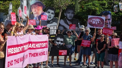 People lift placards and portraits of Israelis held hostage in the Gaza Strip since 2023 on the second anniversary of the Hamas-led Oct 7 attack. (AFP)