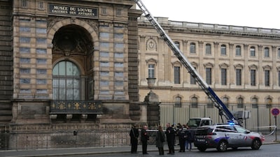 French police officers stand next to a furniture elevator used by robbers to enter the Louvre Museum in Paris. (AFP photo)
