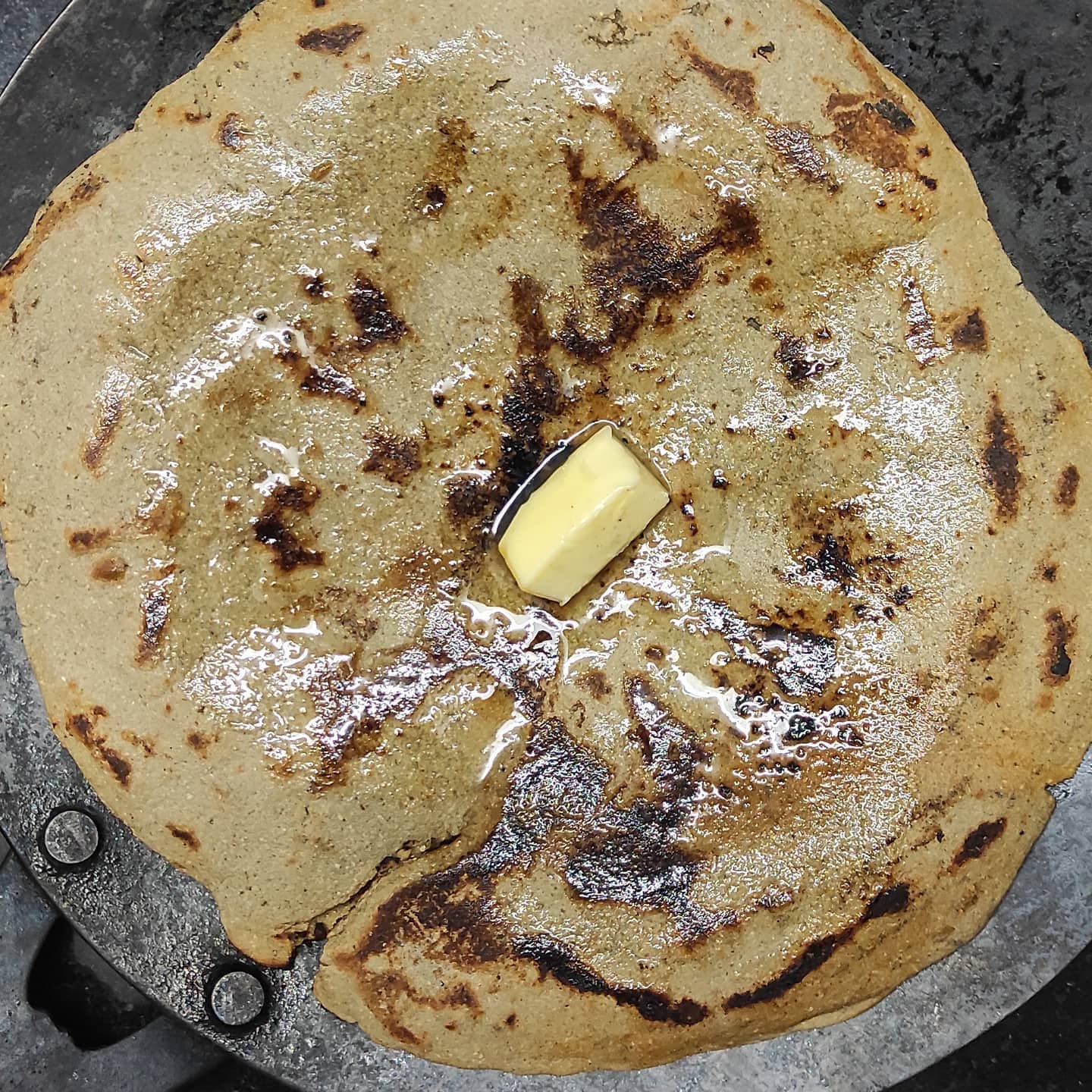 Another local favorite is Rotlo, a millet flatbread topped with jaggery and ghee, often served with Sev Tameta nu Shaak, a spicy tomato gravy.