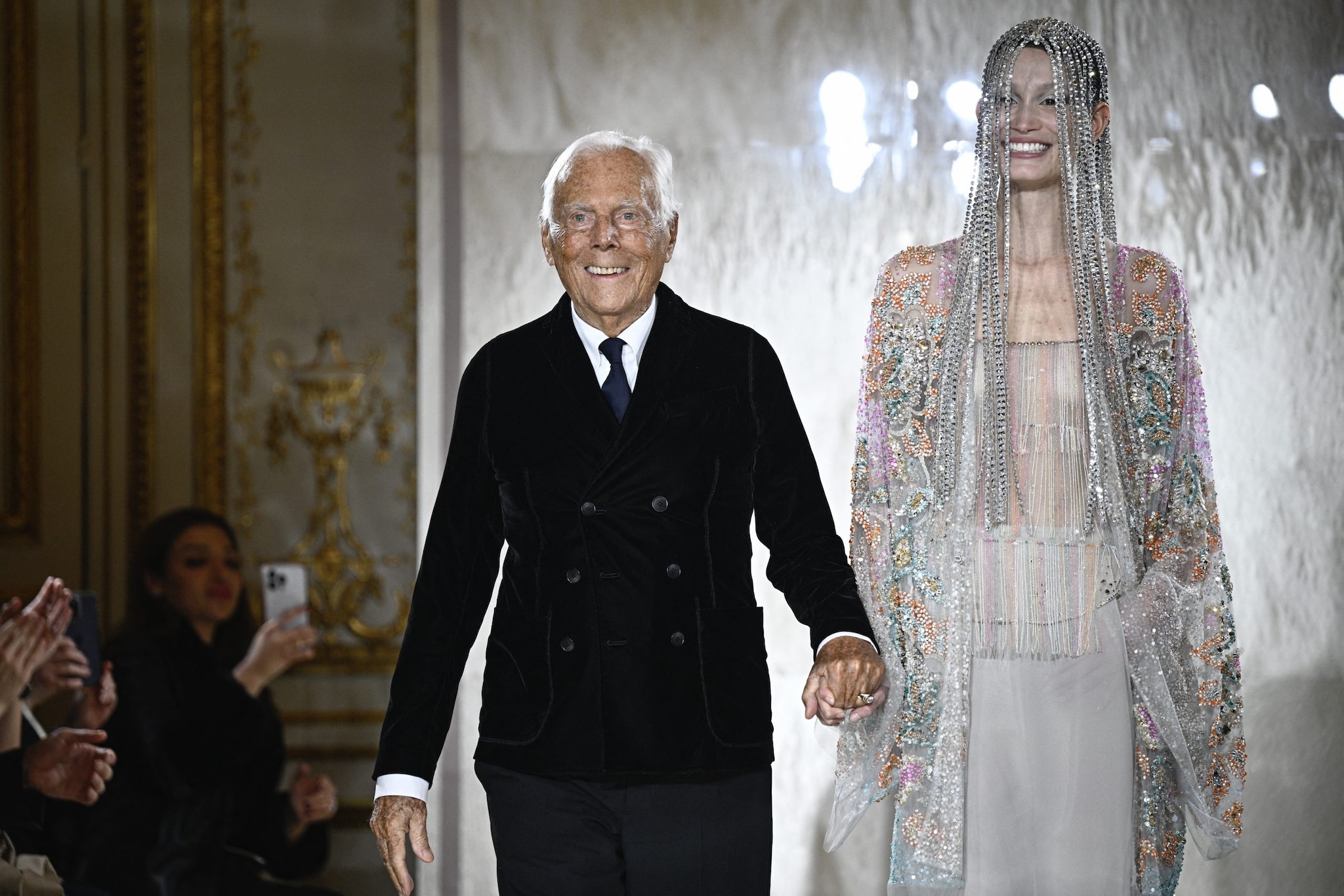 Giorgio Armani, the designer who reshaped modern luxury, acknowledges the audience at a Paris fashion show. He died in 2025 aged 91.