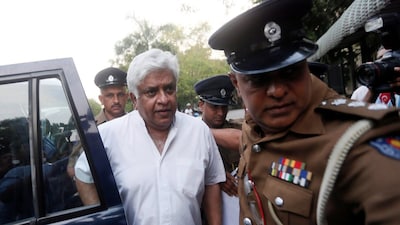 Arjuna Ranatunga being escorted by police (X)