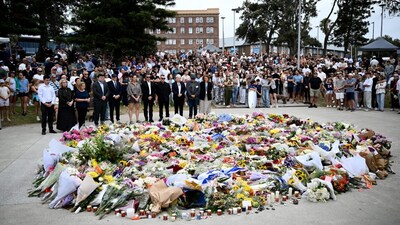 Mourners place flowers at a memorial at Bondi Beach in Sydney, Australia. (Image: Reuters)