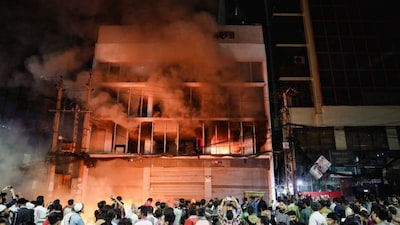 Protester burning down offices of Newspapers as a protest over the death of Osman Hadi (Image: Reuters)