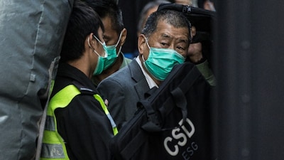 Media tycoon Jimmy Lai (R) is escorted into a Hong Kong Correctional Services van outside the Court of Final Appeal in Hong Kong. (IMAGE: AFP)