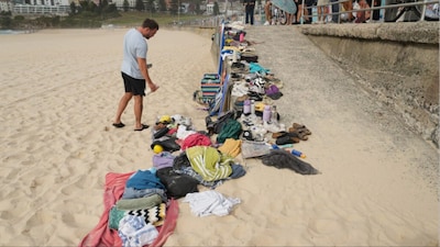 A man looks at belongings stacked up following a shooting at Sydney's Bondi Beach (Photo: AP)