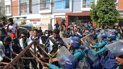 Bangladeshi police try to stop demonstrators as they march towards the assistant Indian high commissioner's office in Rajshahi on December 18. (AFP)