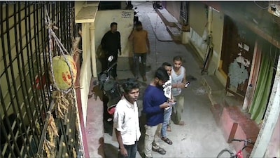 Hyderabad man burns wife to death. Image shows locals outside his house (Video screengrab/CNN-News18)